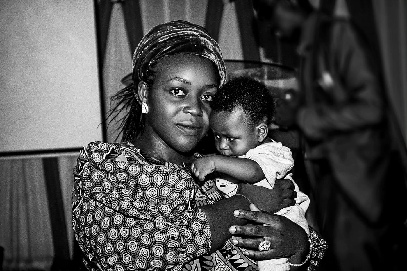 A woman holding a young child close