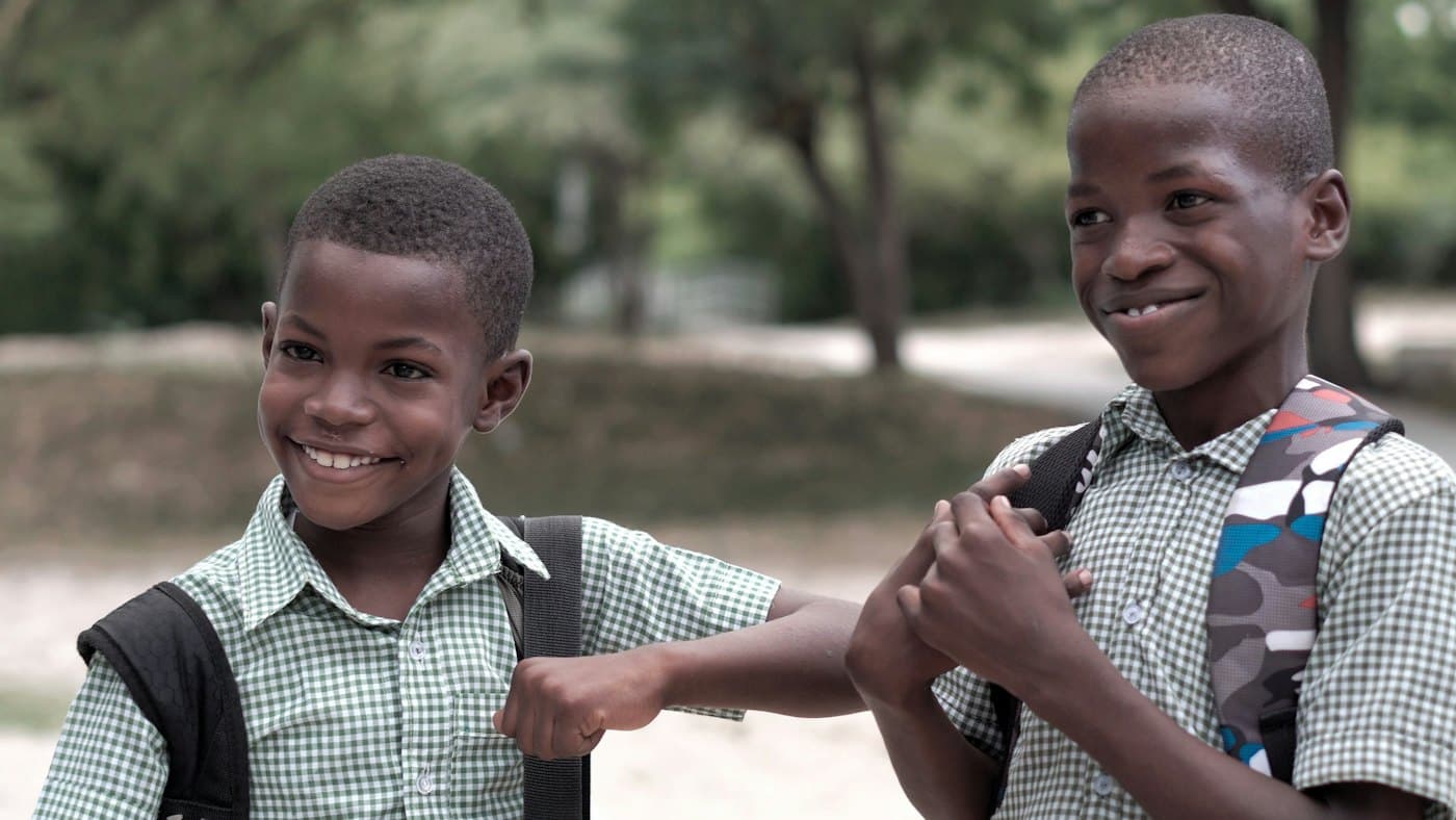 Two smiling boys in school uniform